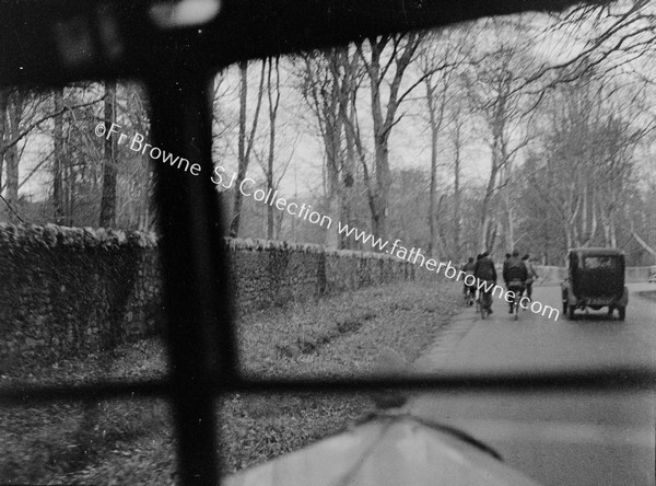 THROUGH WINDSCREEN CYCLISTS AND OLD CAR